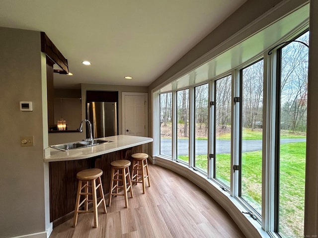 sunroom / solarium featuring french doors and a sink
