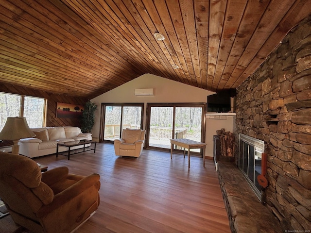 living room with wood finished floors, vaulted ceiling, a fireplace, and wooden ceiling