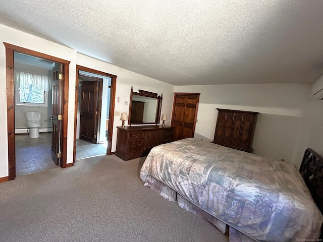 bedroom with carpet flooring, a textured ceiling, and connected bathroom