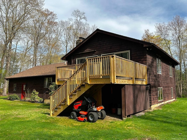rear view of property with stairs, a chimney, a yard, and a deck