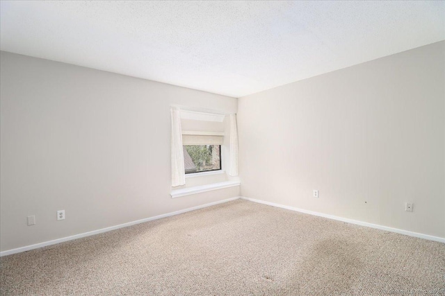 79 Heritage Vlg Unit B, Southbury, CT 06488 - spare room featuring a textured ceiling, carpet flooring, and baseboards