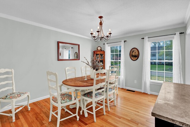 dining area with baseboards, an inviting chandelier, a healthy amount of sunlight, and light wood-style flooring