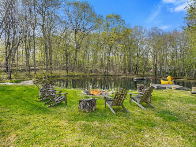 view of yard featuring a water view and a fire pit