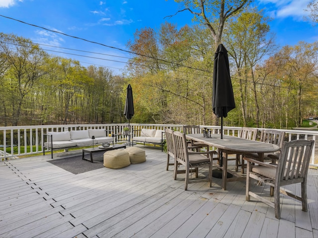 wooden terrace featuring outdoor dining area and an outdoor hangout area