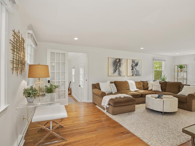 living area with recessed lighting, baseboards, ornamental molding, and wood finished floors