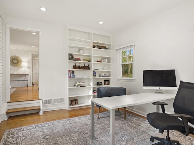office with ornamental molding, recessed lighting, wood finished floors, and visible vents