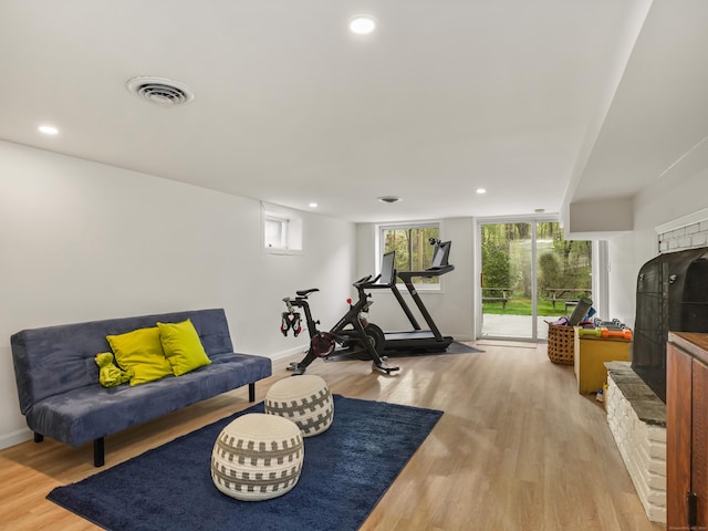 workout area featuring visible vents, recessed lighting, and light wood-style flooring
