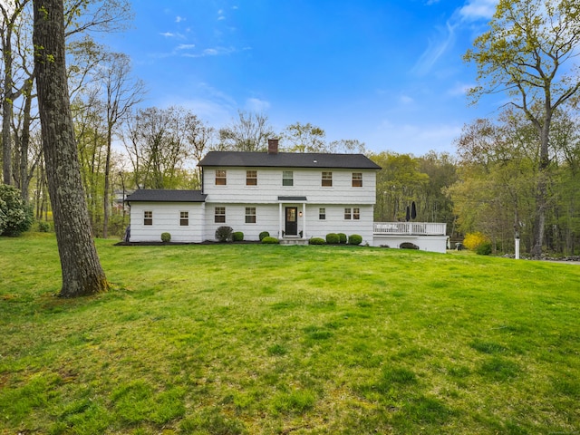 view of front of house with a chimney and a front yard