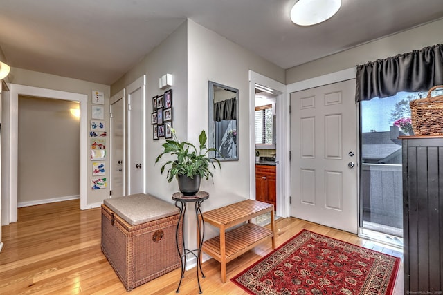foyer featuring baseboards and light wood-style flooring