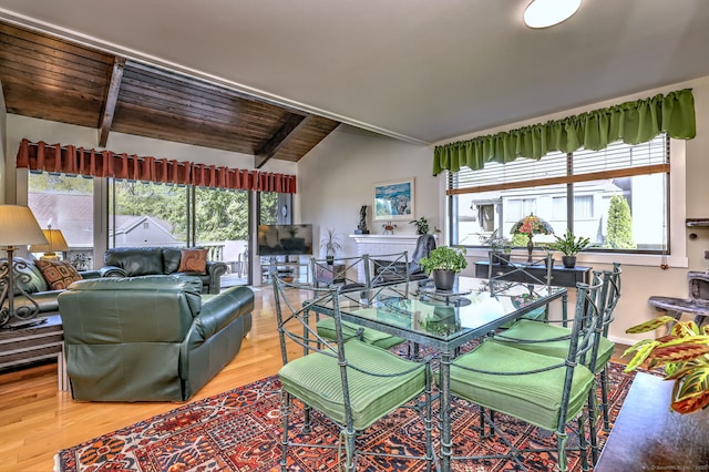 dining area with wood ceiling, plenty of natural light, lofted ceiling with beams, and light wood-type flooring