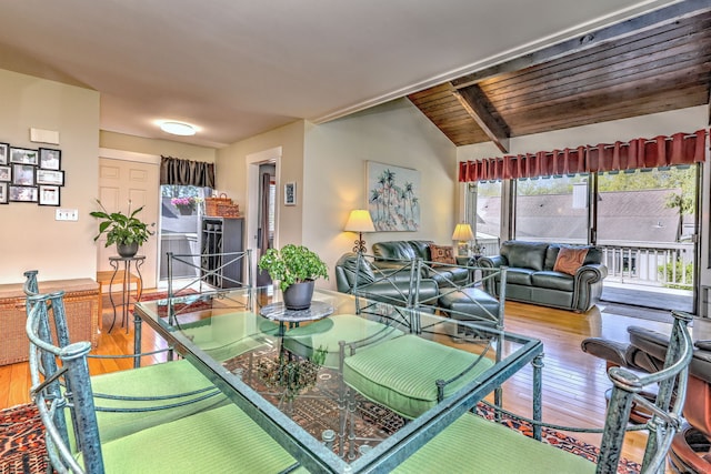 dining area with vaulted ceiling and hardwood / wood-style floors
