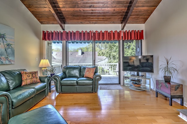 living area with lofted ceiling with beams, wooden ceiling, and hardwood / wood-style flooring
