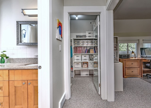 hallway featuring light colored carpet