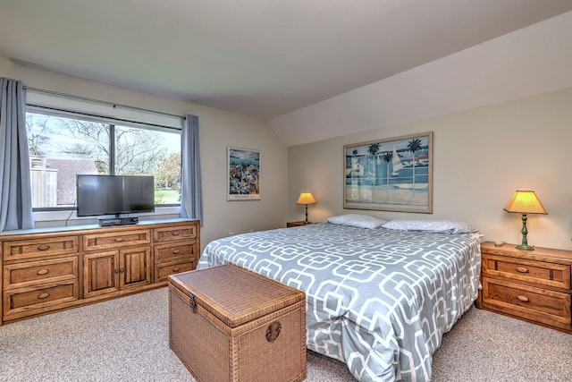 bedroom featuring vaulted ceiling and light carpet