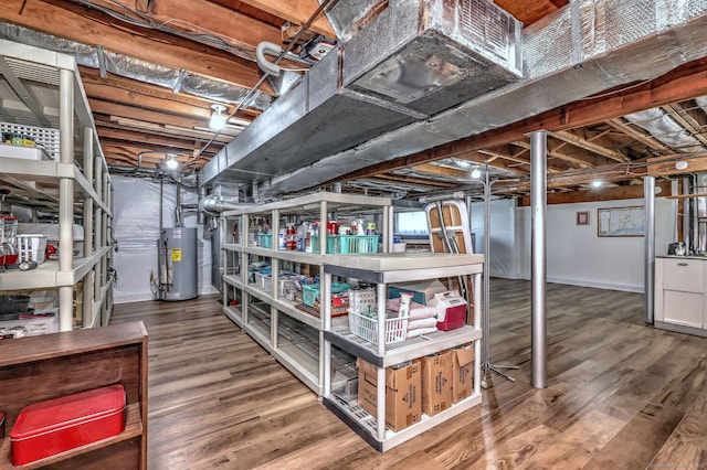 unfinished basement featuring baseboards, water heater, and wood finished floors