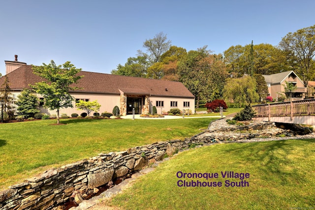 rear view of house featuring a yard