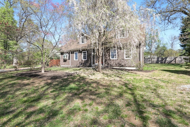 view of front facade featuring fence and a front yard