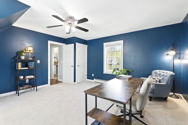 office area with baseboards, carpet, ceiling fan, and a baseboard heating unit