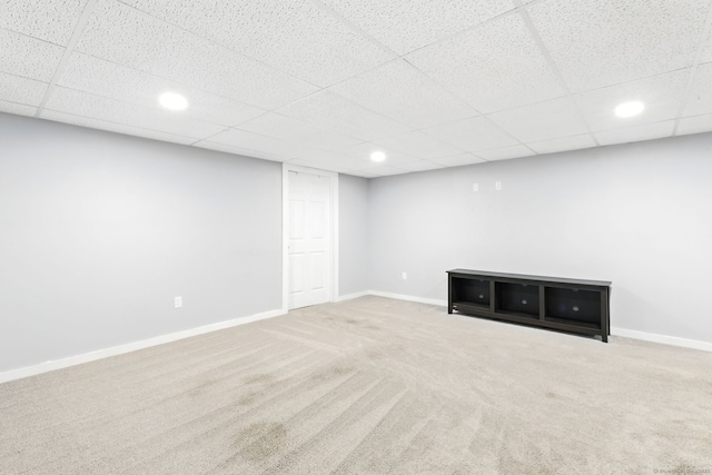 finished basement with baseboards, carpet flooring, recessed lighting, and a paneled ceiling