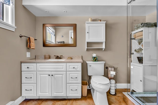 full bathroom featuring toilet, vanity, and baseboards