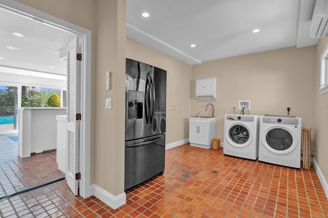 laundry room featuring independent washer and dryer, a wall mounted air conditioner, baseboards, recessed lighting, and cabinet space