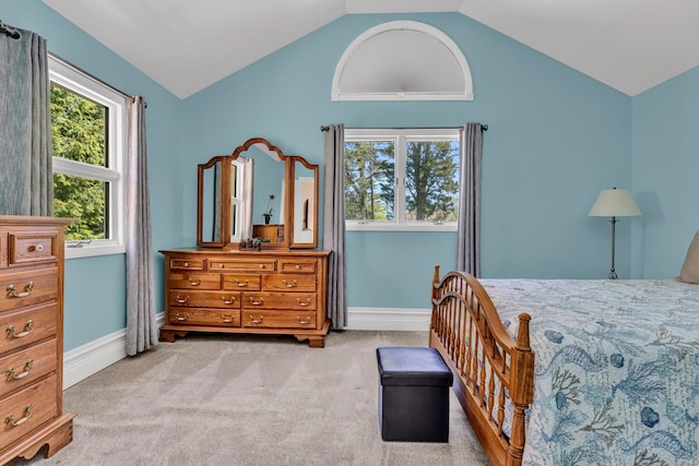 bedroom with vaulted ceiling, carpet, and baseboards
