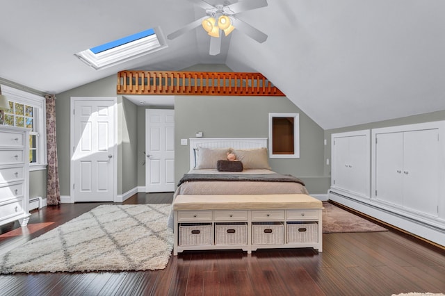 bedroom with a skylight, vaulted ceiling, dark wood-type flooring, baseboards, and ceiling fan