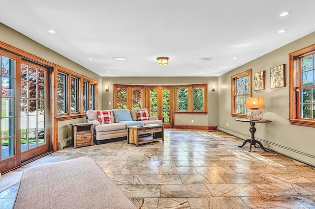 living room with recessed lighting, baseboards, stone finish flooring, and a baseboard radiator