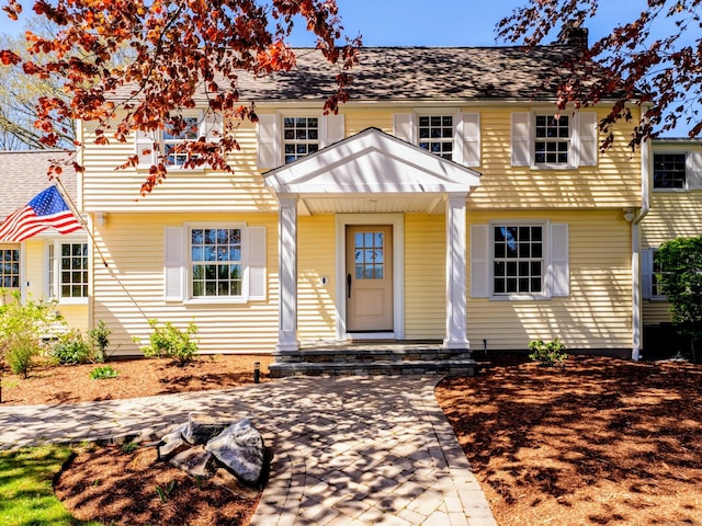 colonial-style house with a chimney