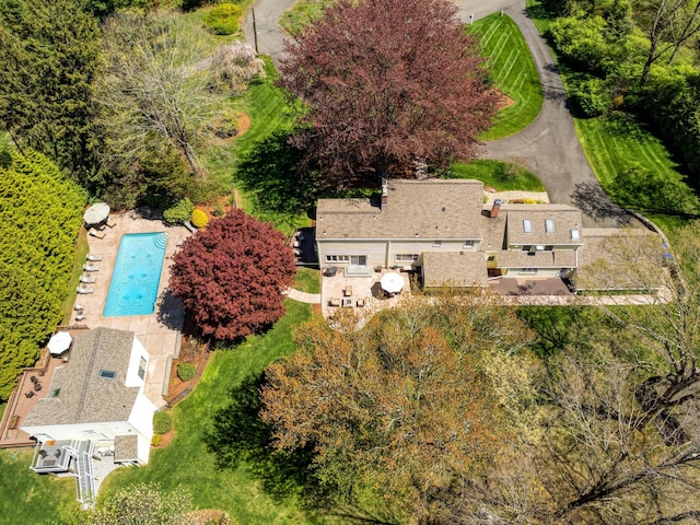 view of subject property with a pool