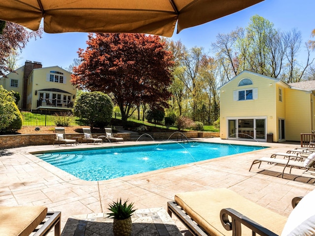 swimming pool featuring a patio, an outdoor structure, fence, and an exterior structure