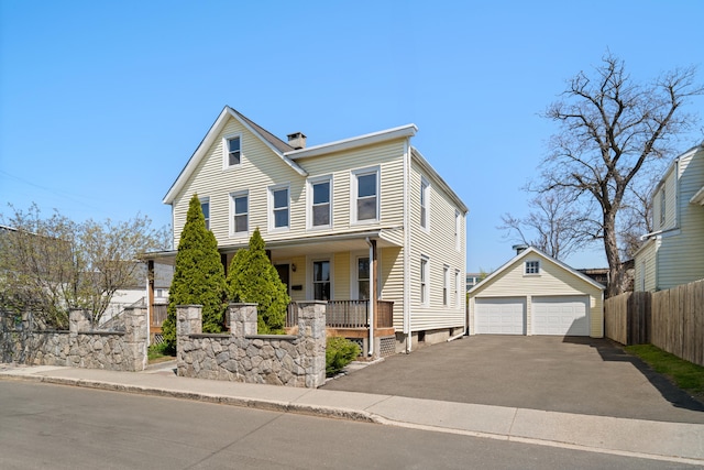 traditional-style home featuring a garage, a chimney, fence, an outdoor structure, and a porch