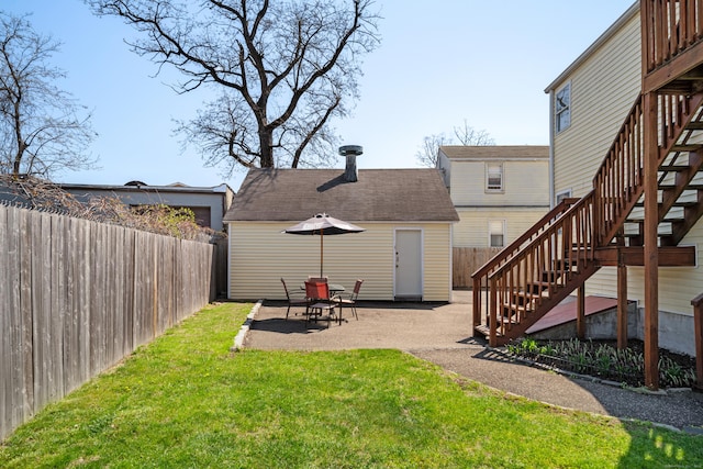exterior space with stairs, a patio area, and a fenced backyard