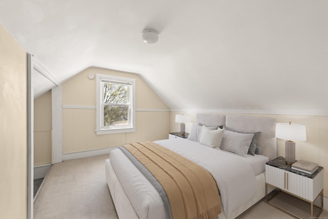 bedroom with lofted ceiling and carpet