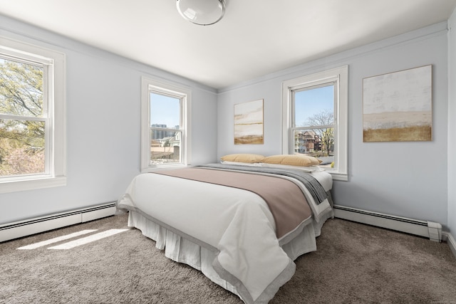 carpeted bedroom with multiple windows and a baseboard radiator