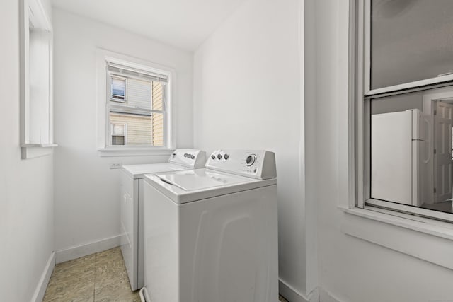 laundry room featuring baseboards, laundry area, and washing machine and clothes dryer