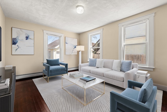 living room featuring a textured ceiling, dark wood-type flooring, and baseboard heating