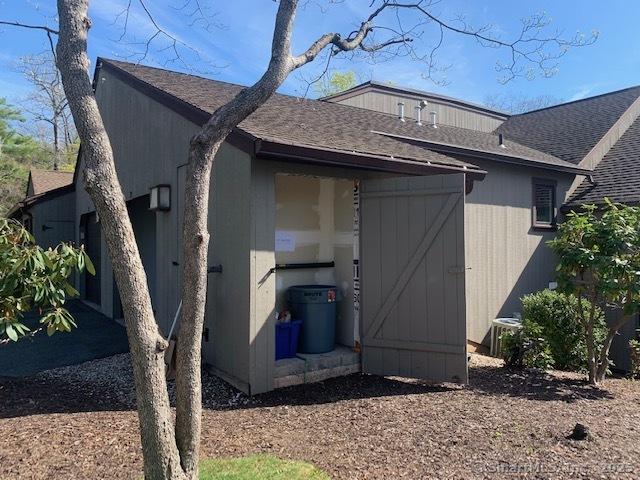 exterior space with roof with shingles