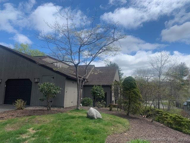 ranch-style home with driveway and an attached garage