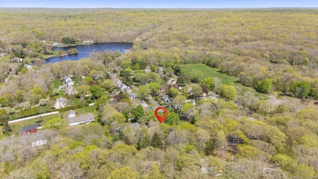 bird's eye view with a water view and a wooded view