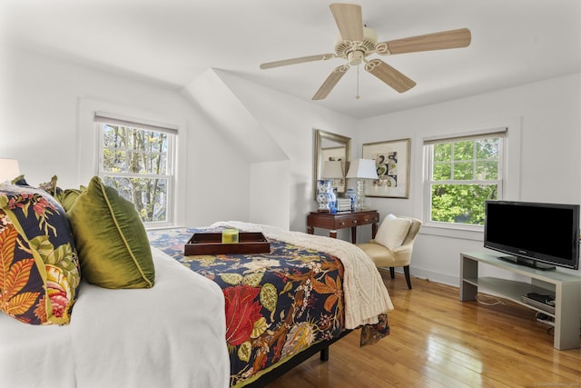 bedroom with baseboards, ceiling fan, and hardwood / wood-style flooring
