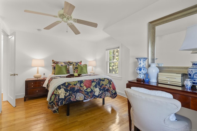 bedroom with baseboards, ceiling fan, and wood finished floors