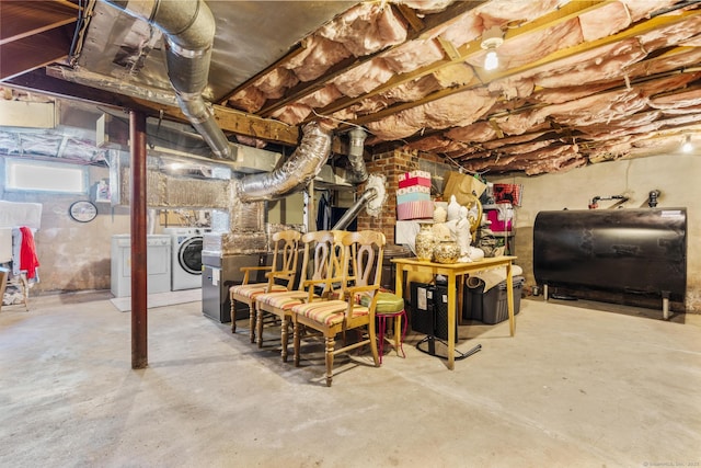 below grade area featuring heating fuel and washer and dryer