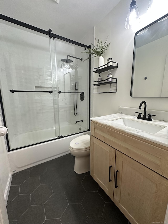 bathroom with toilet, enclosed tub / shower combo, vanity, and tile patterned flooring