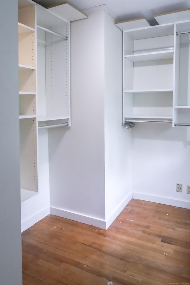 spacious closet featuring wood finished floors