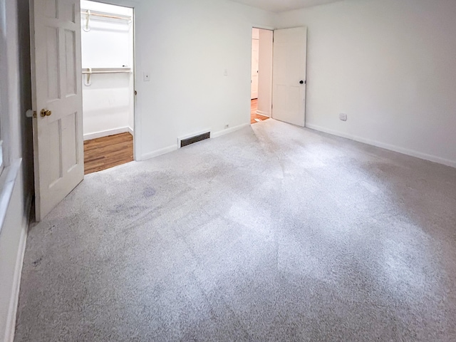 unfurnished bedroom featuring carpet and baseboards