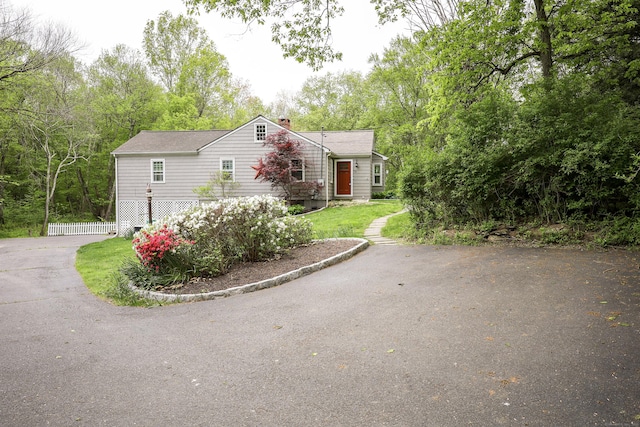 view of front of house featuring driveway and a chimney