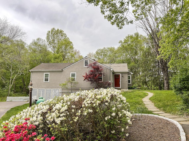 view of home's exterior featuring driveway, fence, and an attached garage