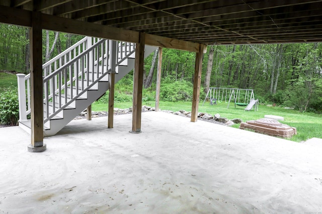 view of patio with a wooded view and a playground
