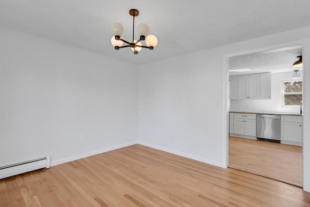 2 Bass Dr, Enfield, CT 06082 - unfurnished dining area with an inviting chandelier, baseboards, a baseboard radiator, and light wood-type flooring